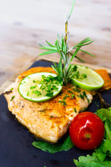 grilled salmon and lemon - french cuisine dish with tomato and salmon