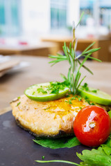 grilled salmon and lemon - french cuisine dish with tomato and salmon