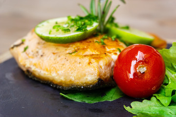 grilled salmon and lemon - french cuisine dish with tomato and salmon