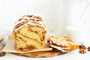 Homemade cakes, cinnamon rolls and icing.