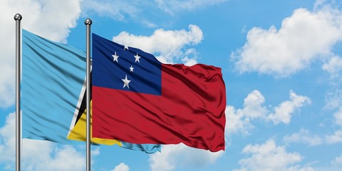 Saint Lucia and Samoa flag waving in the wind against white cloudy blue sky together. Diplomacy concept, international relations.