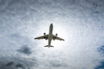 Jet airplane flying in the cloudy skies