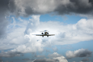Jet airplane flying in the cloudy skies