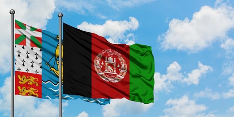 Saint Pierre And Miquelon and Afghanistan flag waving in the wind against white cloudy blue sky together. Diplomacy concept, international relations.