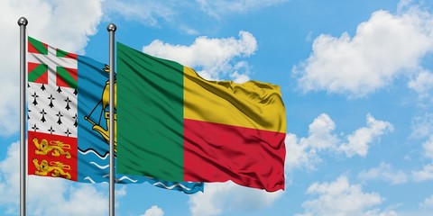 Saint Pierre And Miquelon and Benin flag waving in the wind against white cloudy blue sky together. Diplomacy concept, international relations.