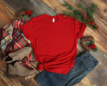 Flat lay mock-up of red t-shirt with Christmas holiday accessories