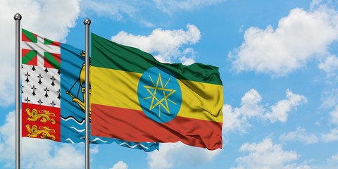 Saint Pierre And Miquelon and Ethiopia flag waving in the wind against white cloudy blue sky together. Diplomacy concept, international relations.