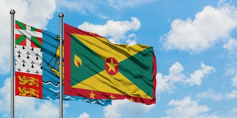Saint Pierre And Miquelon and Grenada flag waving in the wind against white cloudy blue sky together. Diplomacy concept, international relations.