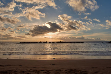 views from Tenerife beach of a sunset behind the island of La Gomera