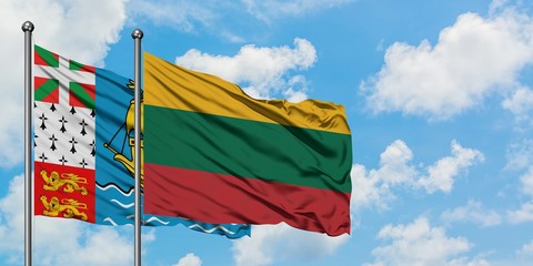 Saint Pierre And Miquelon and Lithuania flag waving in the wind against white cloudy blue sky together. Diplomacy concept, international relations.