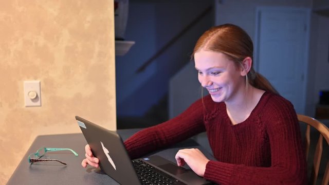 Young Madelyne searches the internet and turns to smile big at the camera