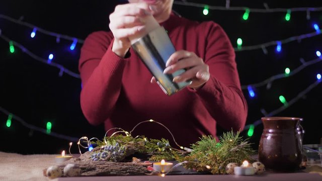 holiday season, homemade traditional egg drink in a glass with ground nutmeg and cinnamon decorating with christmas tree and lights