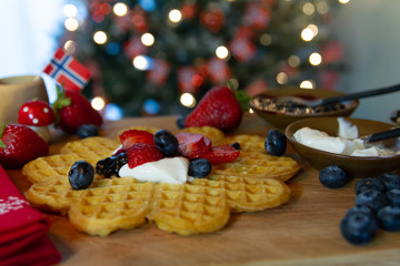 Traditional Scandinavian waffles served with sour cream, jelly, and fresh berries