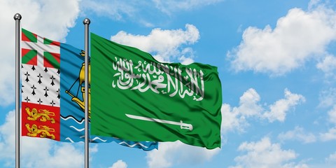 Saint Pierre And Miquelon and Saudi Arabia flag waving in the wind against white cloudy blue sky together. Diplomacy concept, international relations.
