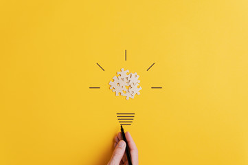 Light bulb over yellow background in vision and idea conceptual image - obrazy, fototapety, plakaty