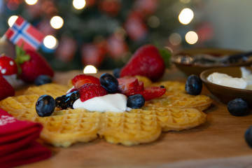 Traditional Scandinavian waffles served with sour cream, jelly, and fresh berries
