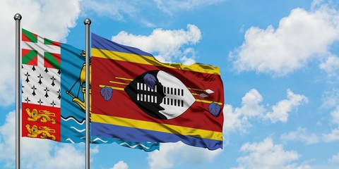 Saint Pierre And Miquelon and Swaziland flag waving in the wind against white cloudy blue sky together. Diplomacy concept, international relations.