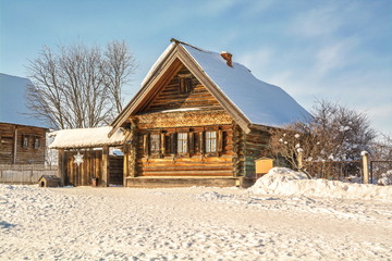 Log cabin in  snowy winter village