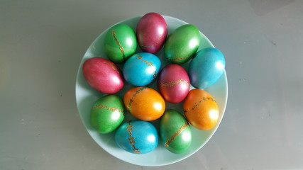 Colorful Easter eggs on a plate. Happy Easter holiday. The view from the top,