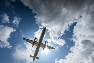 Propeller airplane flying in the cloudy skies