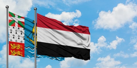 Saint Pierre And Miquelon and Yemen flag waving in the wind against white cloudy blue sky together. Diplomacy concept, international relations.