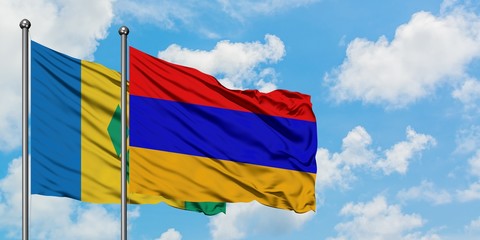 Saint Vincent And The Grenadines and Armenia flag waving in the wind against white cloudy blue sky...