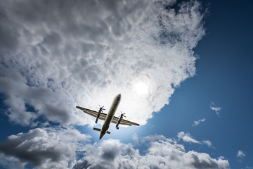 Propeller airplane flying in the cloudy skies