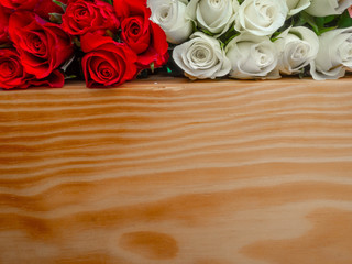Bunch of opened roses of different colors on wooden surface, selective focus