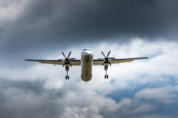 Propeller airplane flying in the cloudy skies