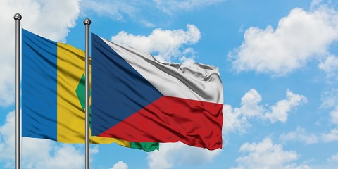Saint Vincent And The Grenadines and Czech Republic flag waving in the wind against white cloudy...