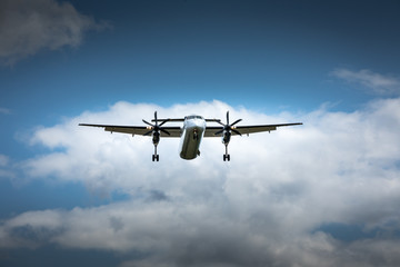 Propeller airplane flying in the cloudy skies