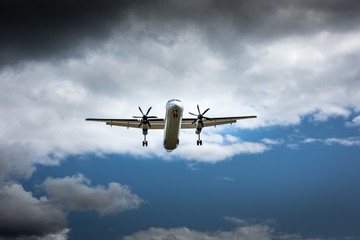 Propeller airplane flying in the cloudy skies