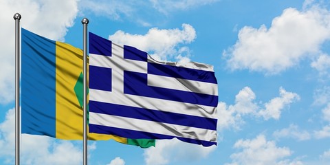 Saint Vincent And The Grenadines and Greece flag waving in the wind against white cloudy blue sky...
