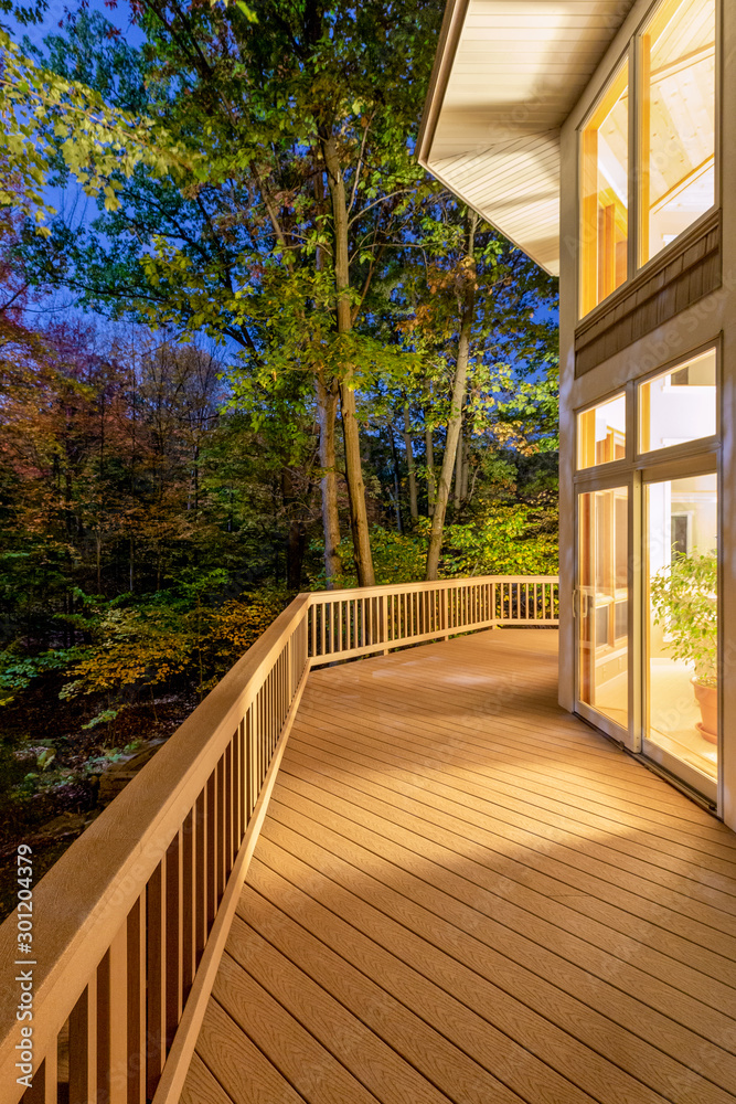 Wall mural deck on home in woods at night