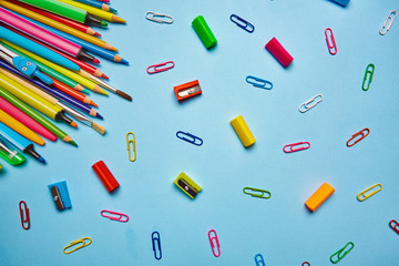 On the light blue table scattered a bright stationery