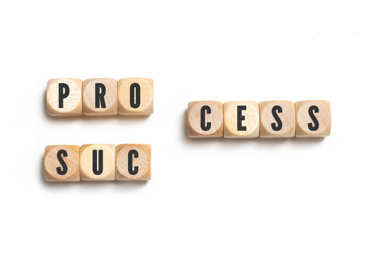cubes forming either the words "process" or "success" on white background 