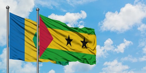 Saint Vincent And The Grenadines and Sao Tome And Principe flag waving in the wind against white cloudy blue sky together. Diplomacy concept, international relations.