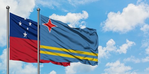 Samoa and Aruba flag waving in the wind against white cloudy blue sky together. Diplomacy concept, international relations.