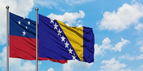 Samoa and Bosnia Herzegovina flag waving in the wind against white cloudy blue sky together....