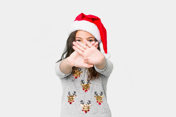 Little girl celebrating christmas day doing a denial gesture