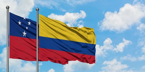 Samoa and Colombia flag waving in the wind against white cloudy blue sky together. Diplomacy concept, international relations.