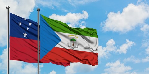 Samoa and Equatorial Guinea flag waving in the wind against white cloudy blue sky together....