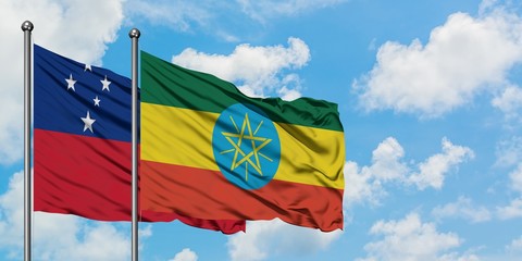 Samoa and Ethiopia flag waving in the wind against white cloudy blue sky together. Diplomacy concept, international relations.