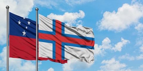 Samoa and Faroe Islands flag waving in the wind against white cloudy blue sky together. Diplomacy concept, international relations.