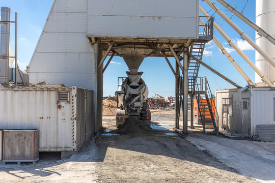 Concrete mixer fills stock at construction site