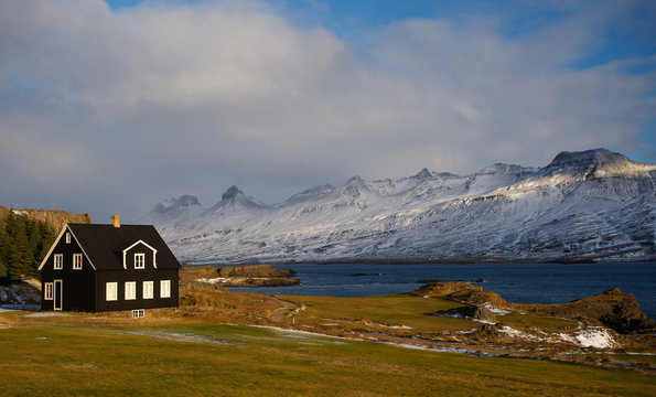 Traditional Black House In Iceland By The Fjord On The Coast In Winter