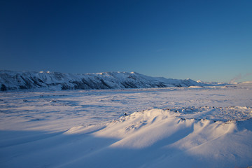 Naklejka na ściany i meble Winter landscape in Iceland with snow and mountains