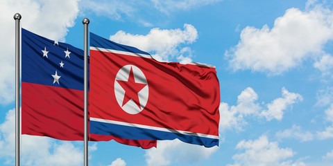 Samoa and North Korea flag waving in the wind against white cloudy blue sky together. Diplomacy concept, international relations.