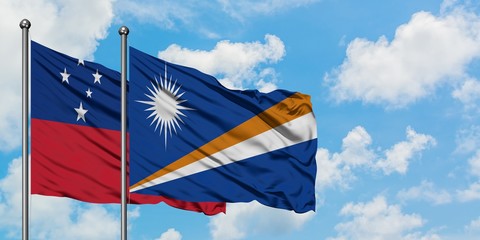 Samoa and Marshall Islands flag waving in the wind against white cloudy blue sky together. Diplomacy concept, international relations.