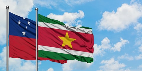 Samoa and Suriname flag waving in the wind against white cloudy blue sky together. Diplomacy concept, international relations.